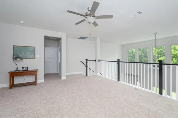 a view of a livingroom with furniture and a ceiling fan