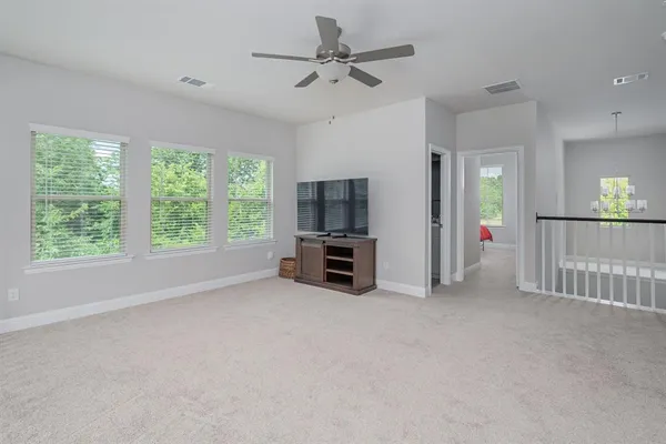 a view of a livingroom with furniture and a ceiling fan