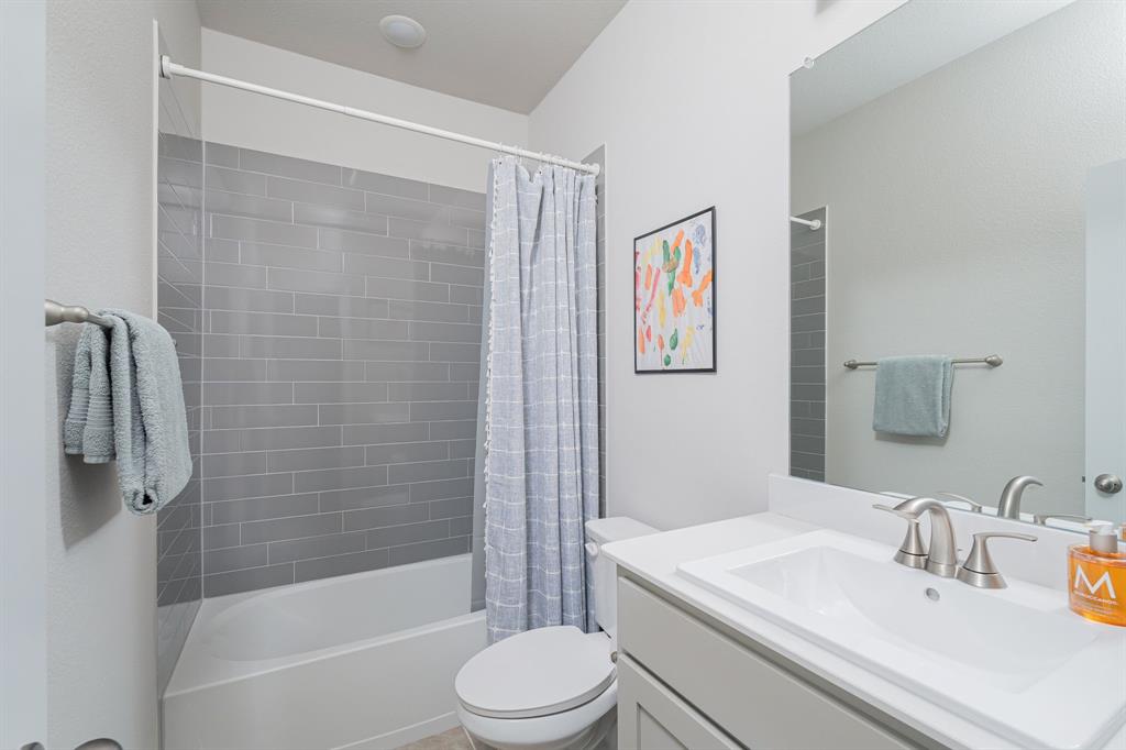 1412 Bear Path Way Gunter, TX 75058 - Photo 19 of 37 a bathroom with a sink a toilet and shower
