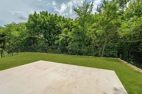 a view of field of grass and trees