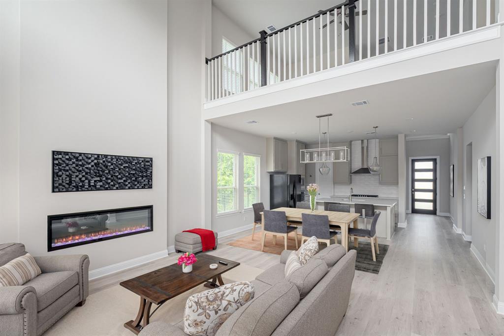 1412 Bear Path Way Gunter, TX 75058 - Photo 5 of 37 a living room with furniture a fireplace and a large window