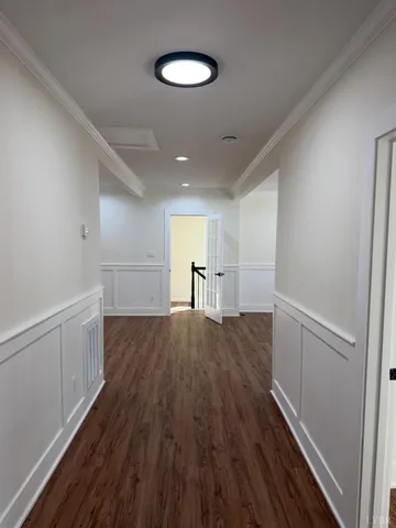 a view of empty room with wooden floor