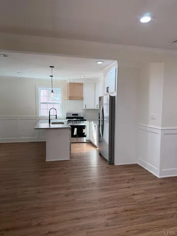 a kitchen with stainless steel appliances a refrigerator and a stove top oven