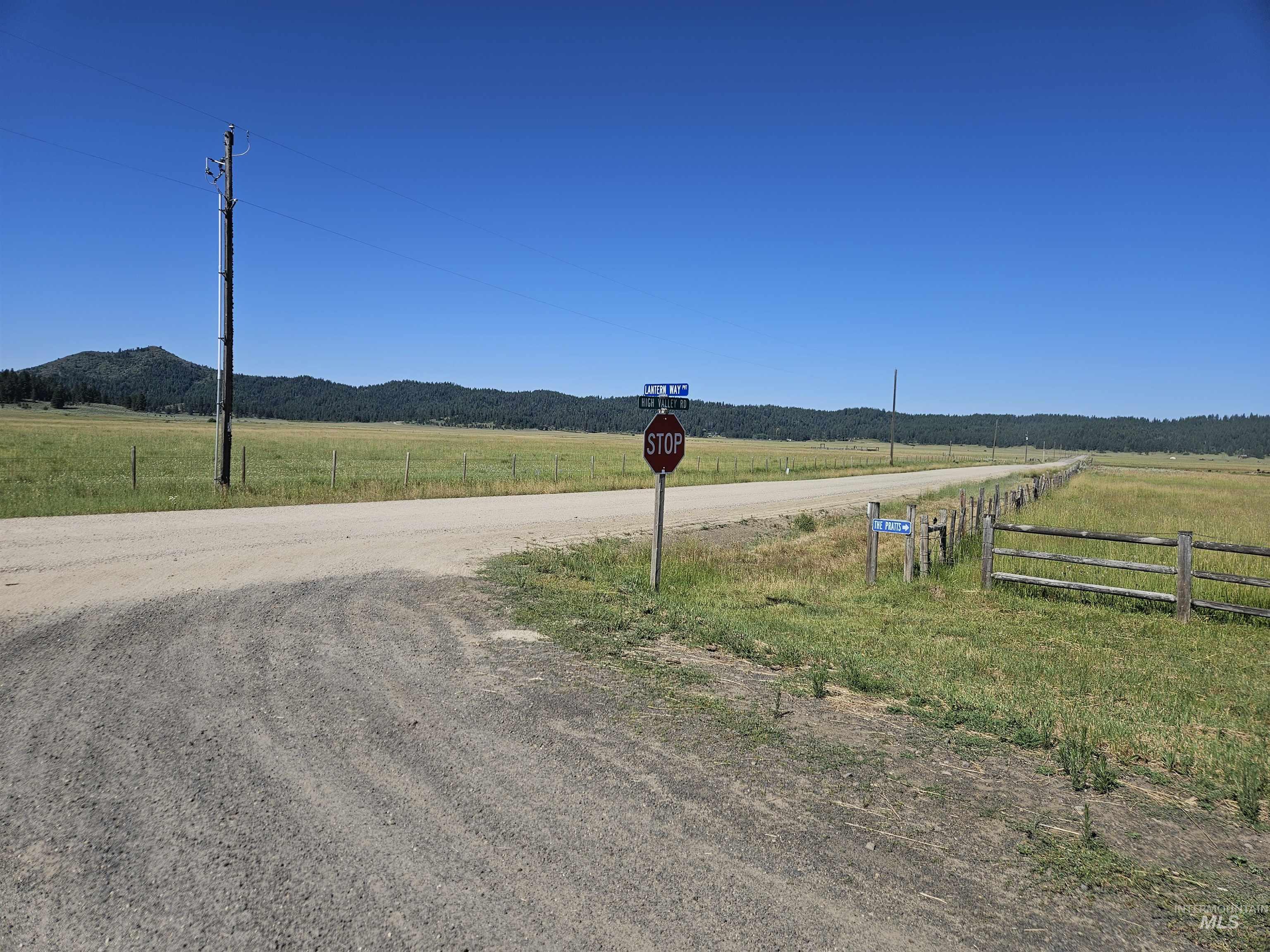 110 Lantern Way Cascade, ID 83611 - Photo 6 of 32 View of dirt / gravel road featuring a rural view, traffic signs, and a mountain view