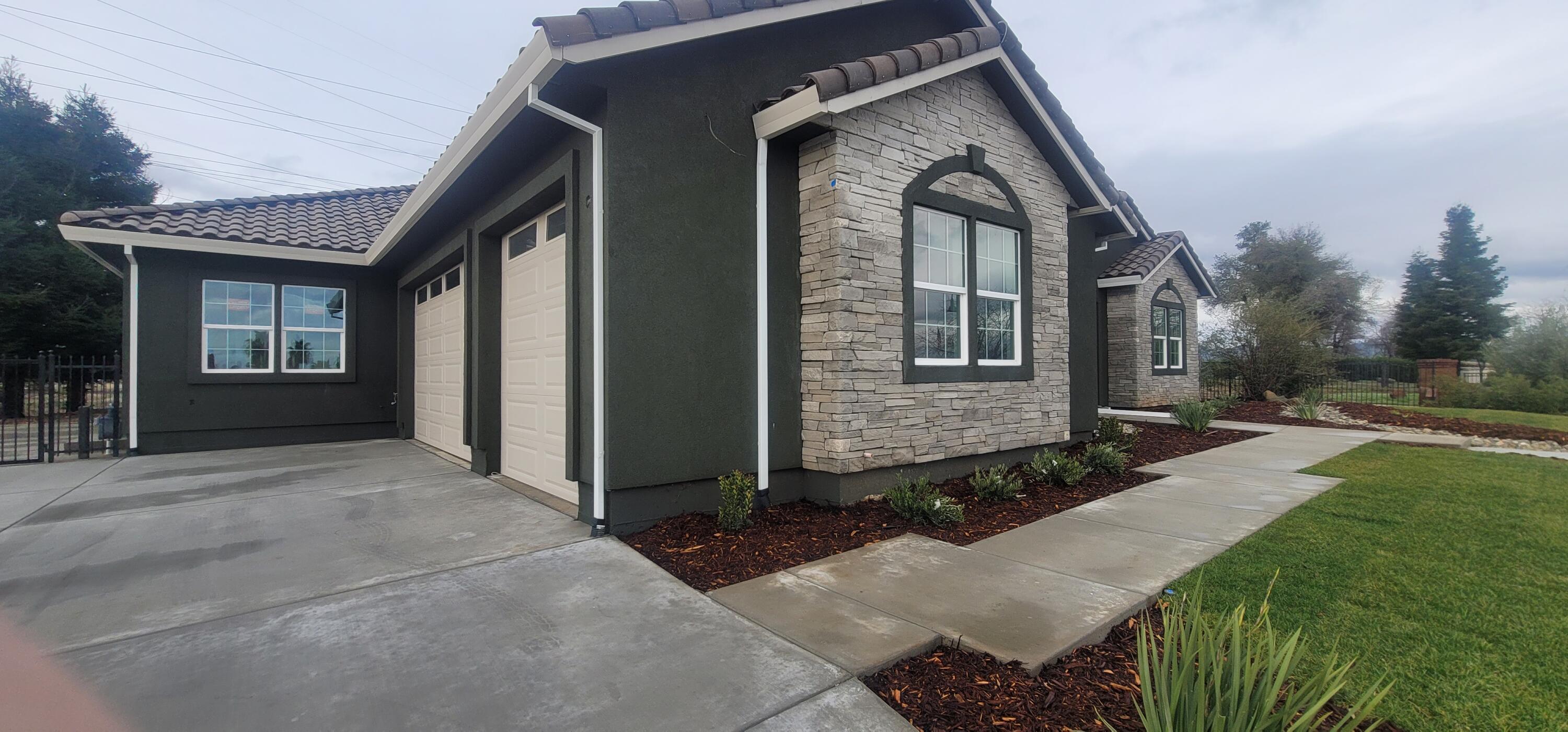 910 Santa Cruz Drive Redding, CA 96003 - Photo 2 of 28 a front view of a house with a yard