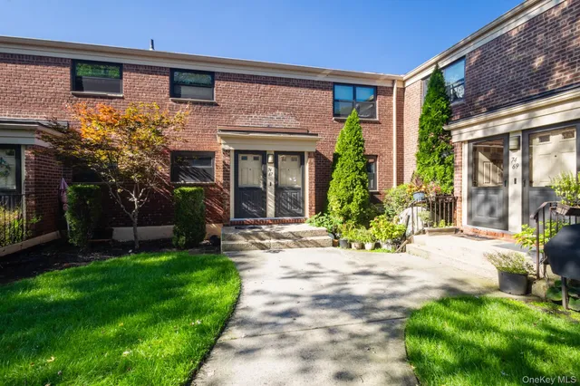 a view of a house with potted plants and a large window