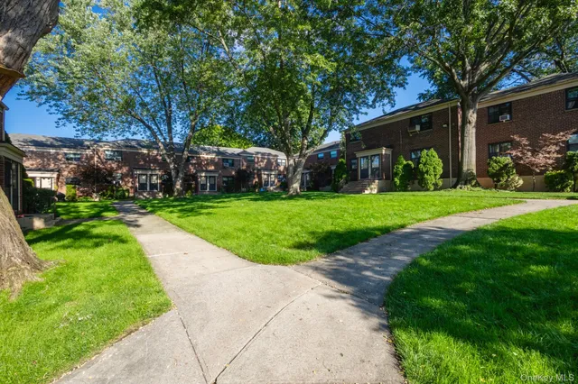 a view of a park with a house in the background