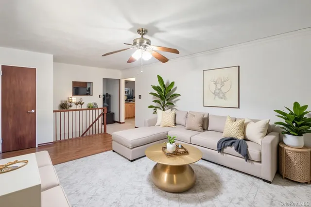 a living room with furniture and a chandelier