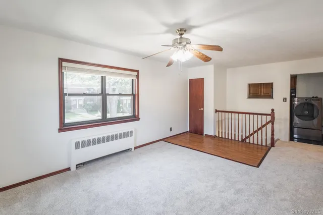 a view of a livingroom with a ceiling fan and window