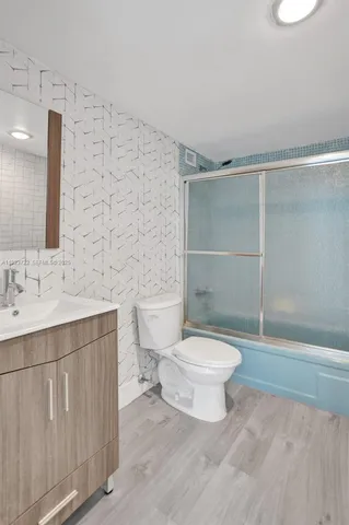 a bathroom with a toilet a sink and a shower