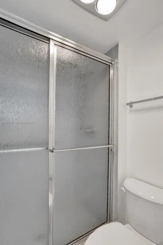 a bathroom with a shower and a toilet