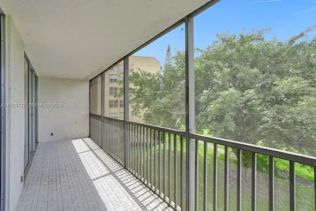 a view of a balcony with wooden floor