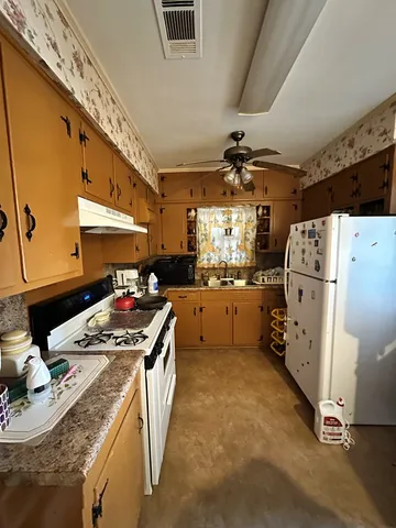 a kitchen filled with a stove a refrigerator and a stove