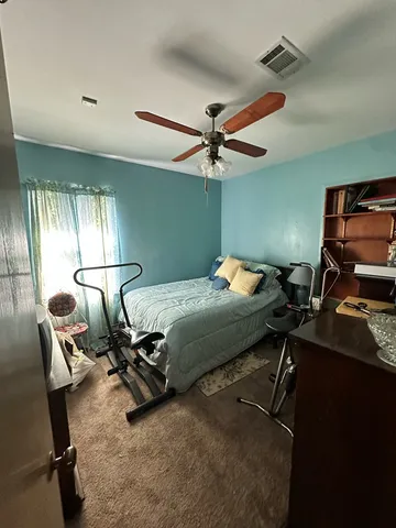 a bedroom with a bed and gym machine