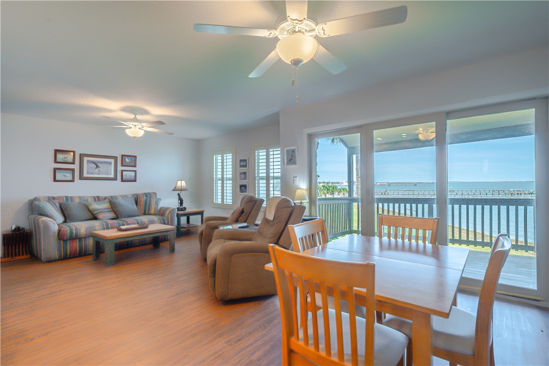620 Fulton Beach Road, Unit 708 Rockport, TX 78382 - Photo 6 of 38 a living room with furniture dining table and a large window