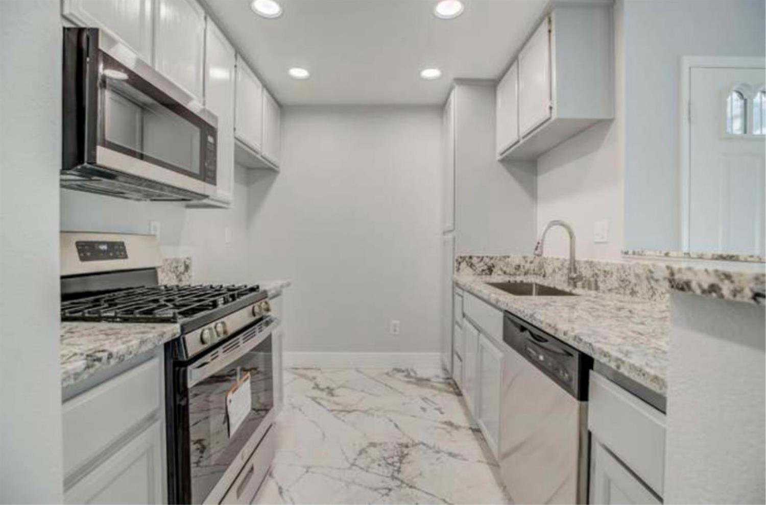 8020 Walerga Road, Unit 1147 Antelope, CA 95843 - Photo 4 of 20 a kitchen with stainless steel appliances granite countertop a lot of cabinets a stove and a sink