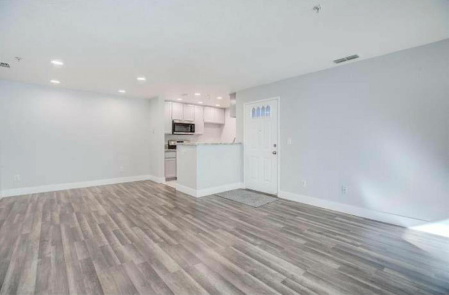 8020 Walerga Road, Unit 1147 Antelope, CA 95843 - Photo 10 of 20 a view of a kitchen with a microwave and wooden floor