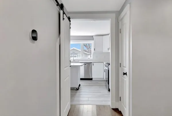 a view of a kitchen from the hallway with a outdoor space