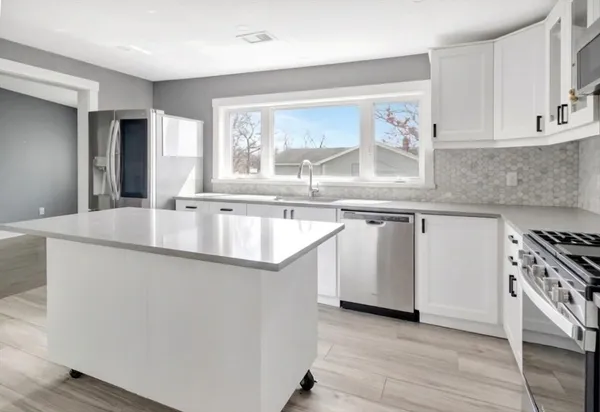 a kitchen with a sink and a window