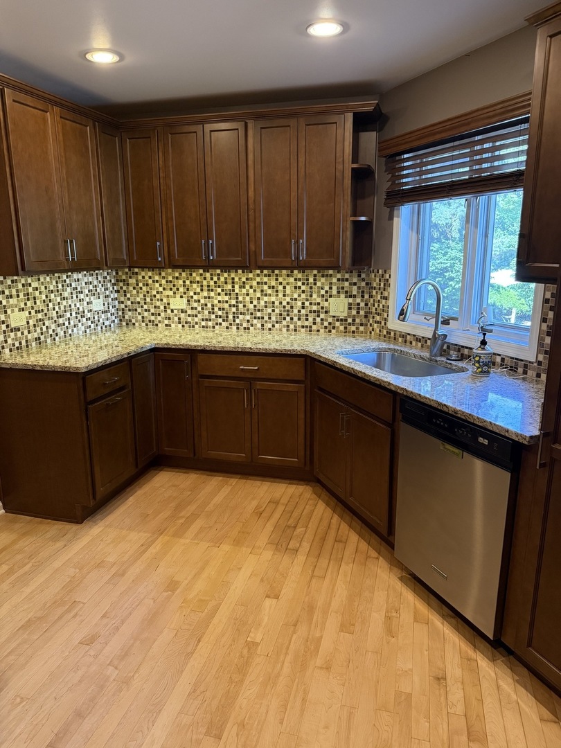 414 South Dee Road Park Ridge, IL 60068 - Photo 5 of 37 a kitchen with wooden cabinets and sink