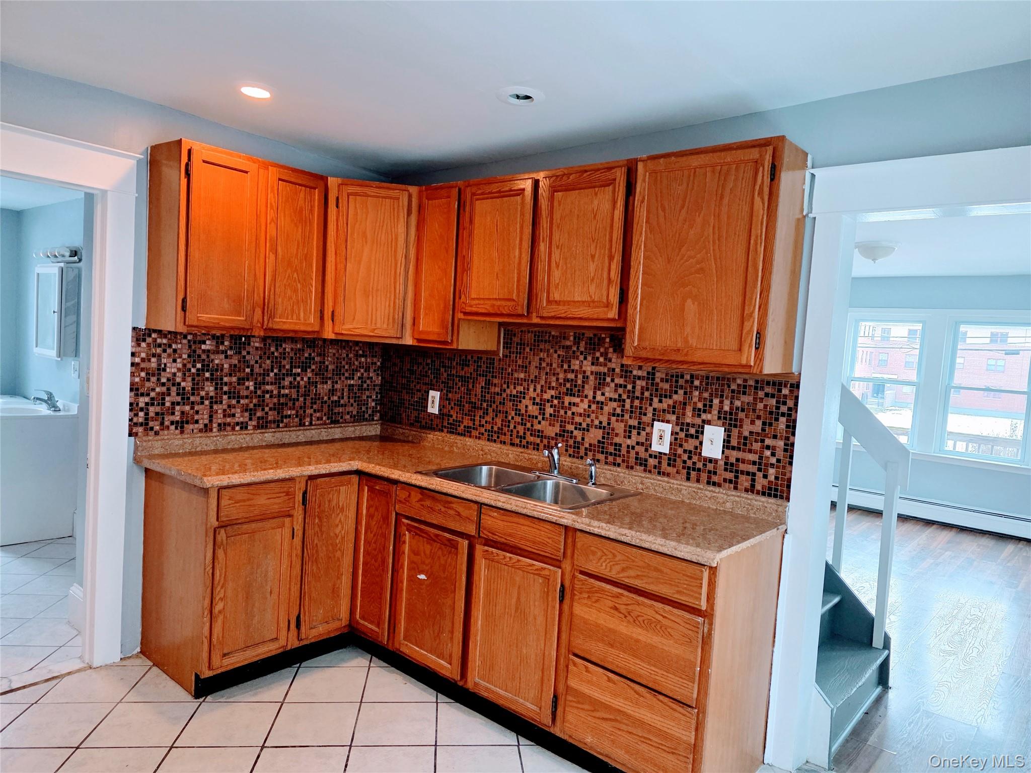 210 Smith Street Poughkeepsie, NY 12601 - Photo 13 of 44 a kitchen with stainless steel appliances a sink stove and cabinets