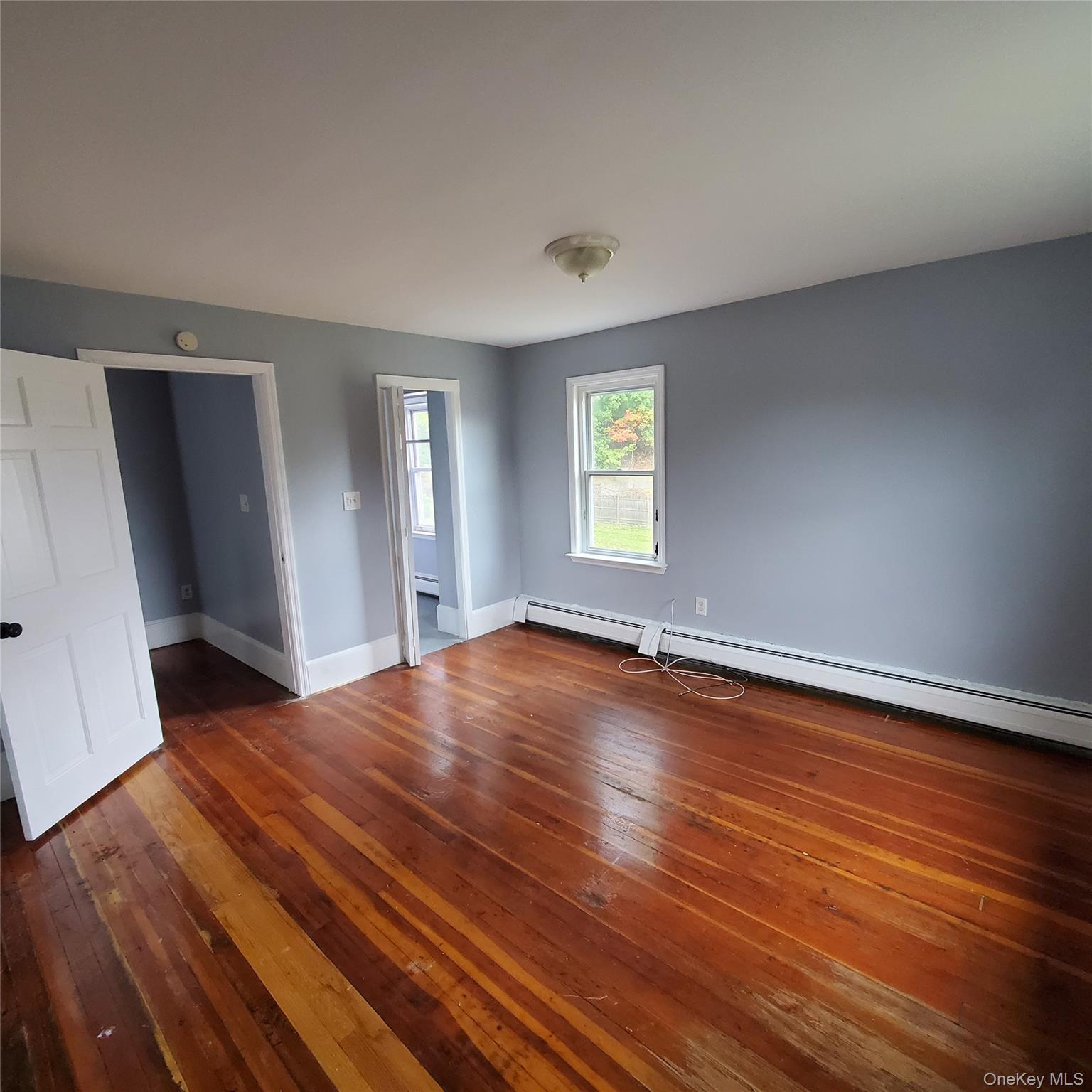 210 Smith Street Poughkeepsie, NY 12601 - Photo 18 of 44 an empty room with wooden floor and windows