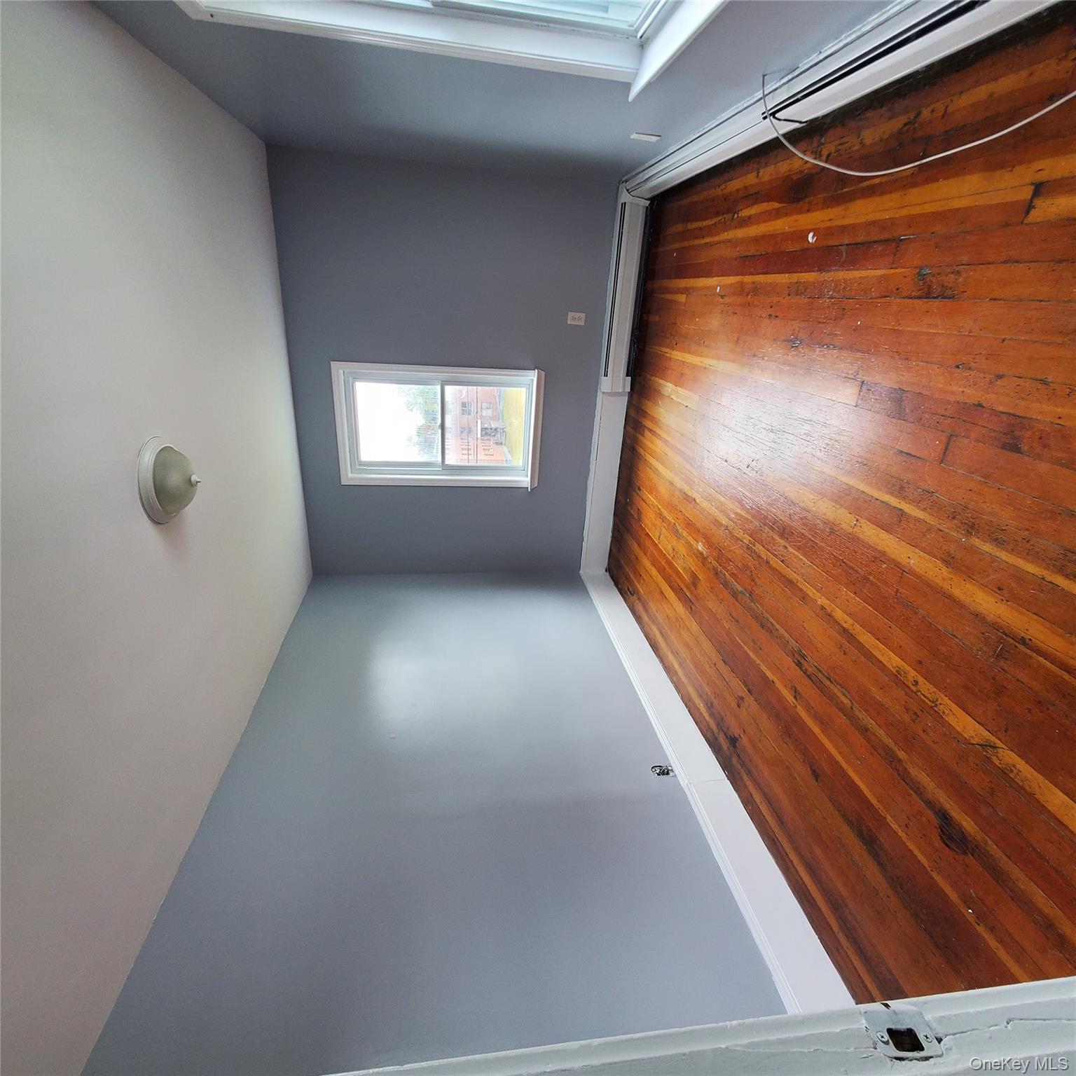 210 Smith Street Poughkeepsie, NY 12601 - Photo 20 of 44 an empty room with wooden floor and windows