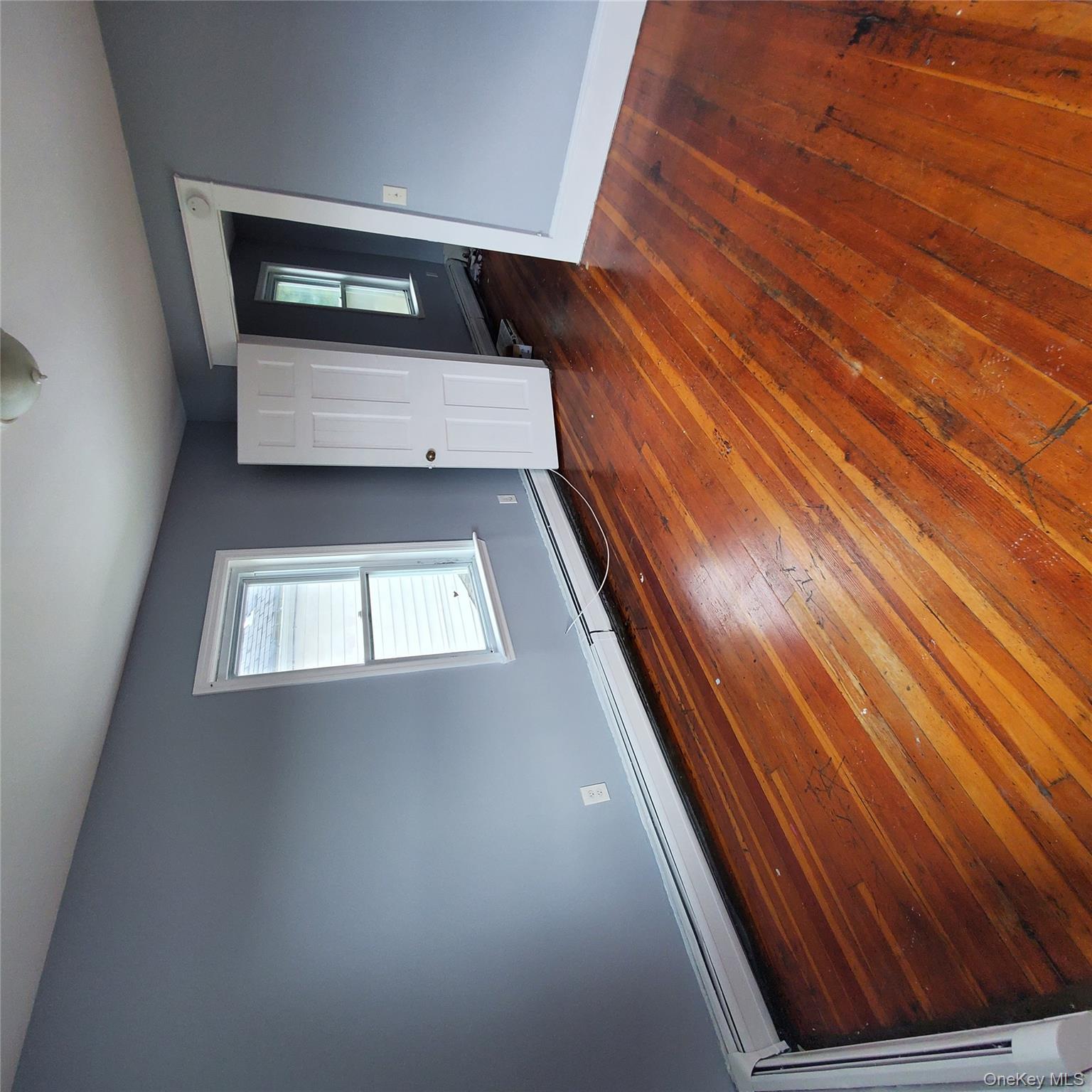 210 Smith Street Poughkeepsie, NY 12601 - Photo 24 of 44 an empty room with wooden floor and windows