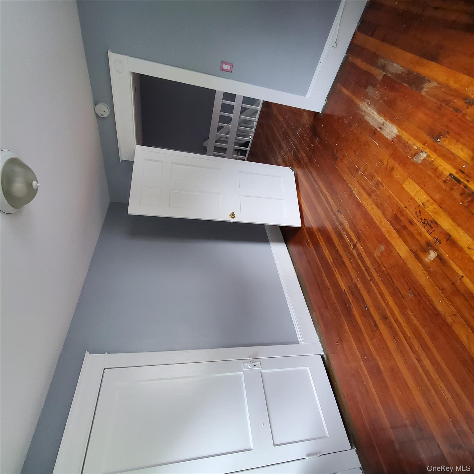 210 Smith Street Poughkeepsie, NY 12601 - Photo 26 of 44 Unfurnished bedroom featuring dark wood-style flooring and baseboards