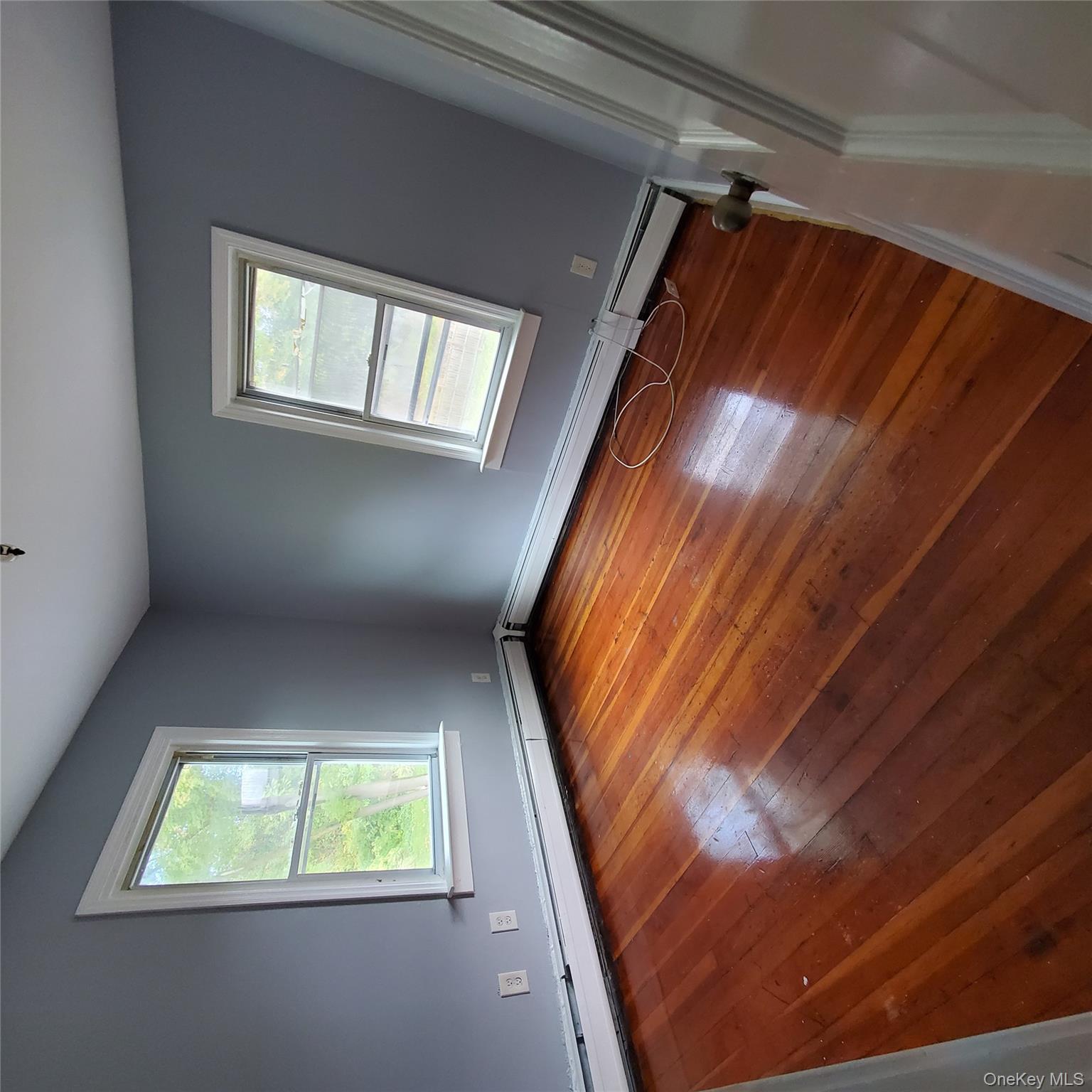 210 Smith Street Poughkeepsie, NY 12601 - Photo 29 of 44 Empty room with hardwood / wood-style flooring and a baseboard heating unit