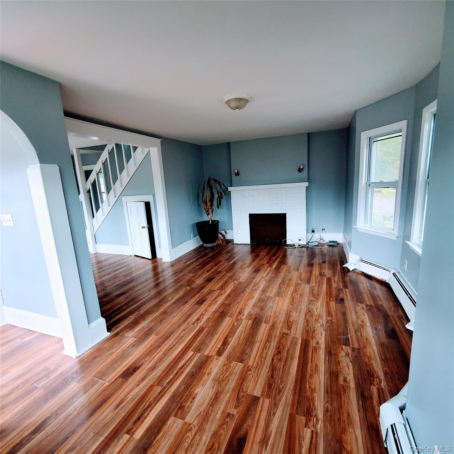 210 Smith Street Poughkeepsie, NY 12601 - Photo 3 of 44 a view of empty room with wooden floor and fan