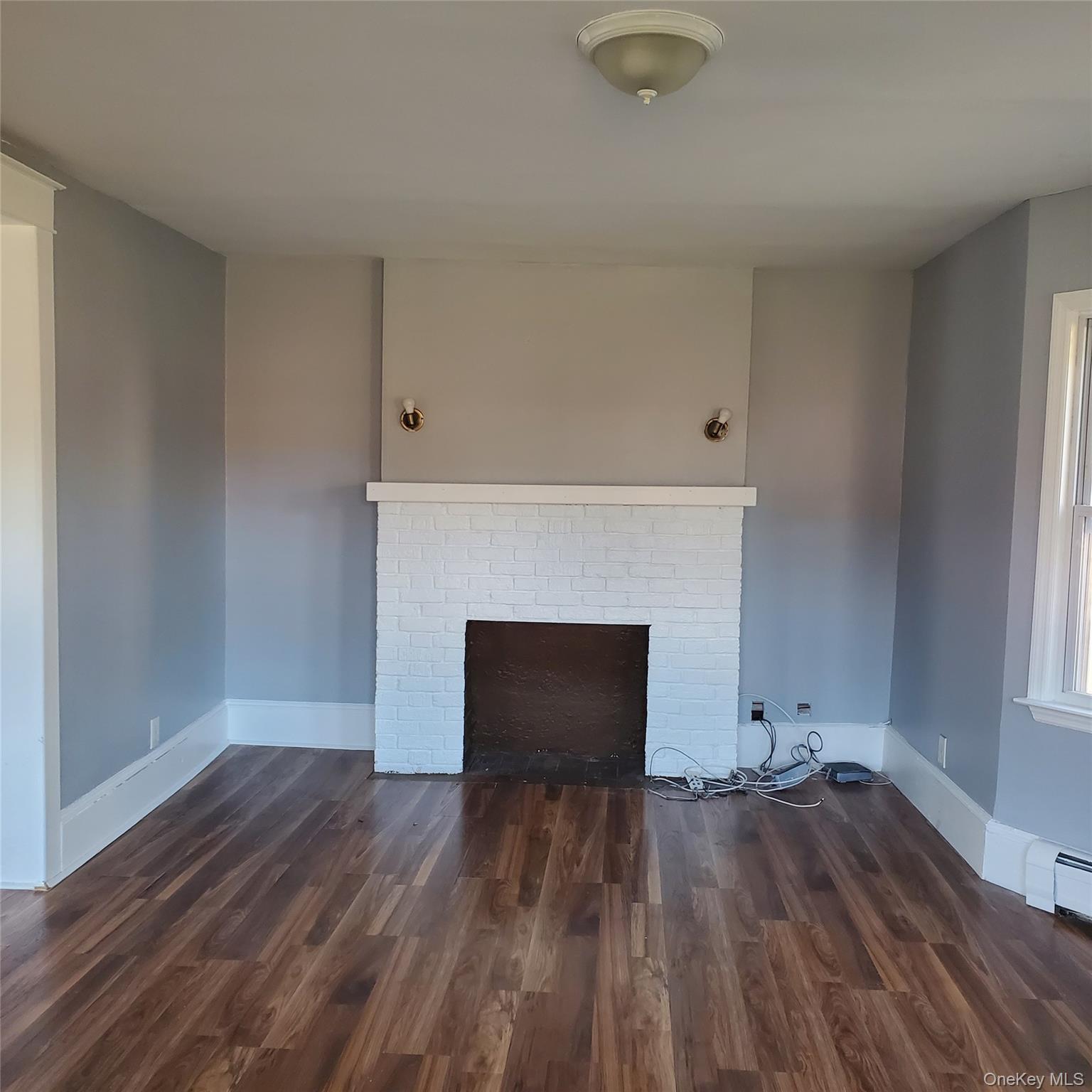 210 Smith Street Poughkeepsie, NY 12601 - Photo 4 of 44 an empty room with wooden floor and a window
