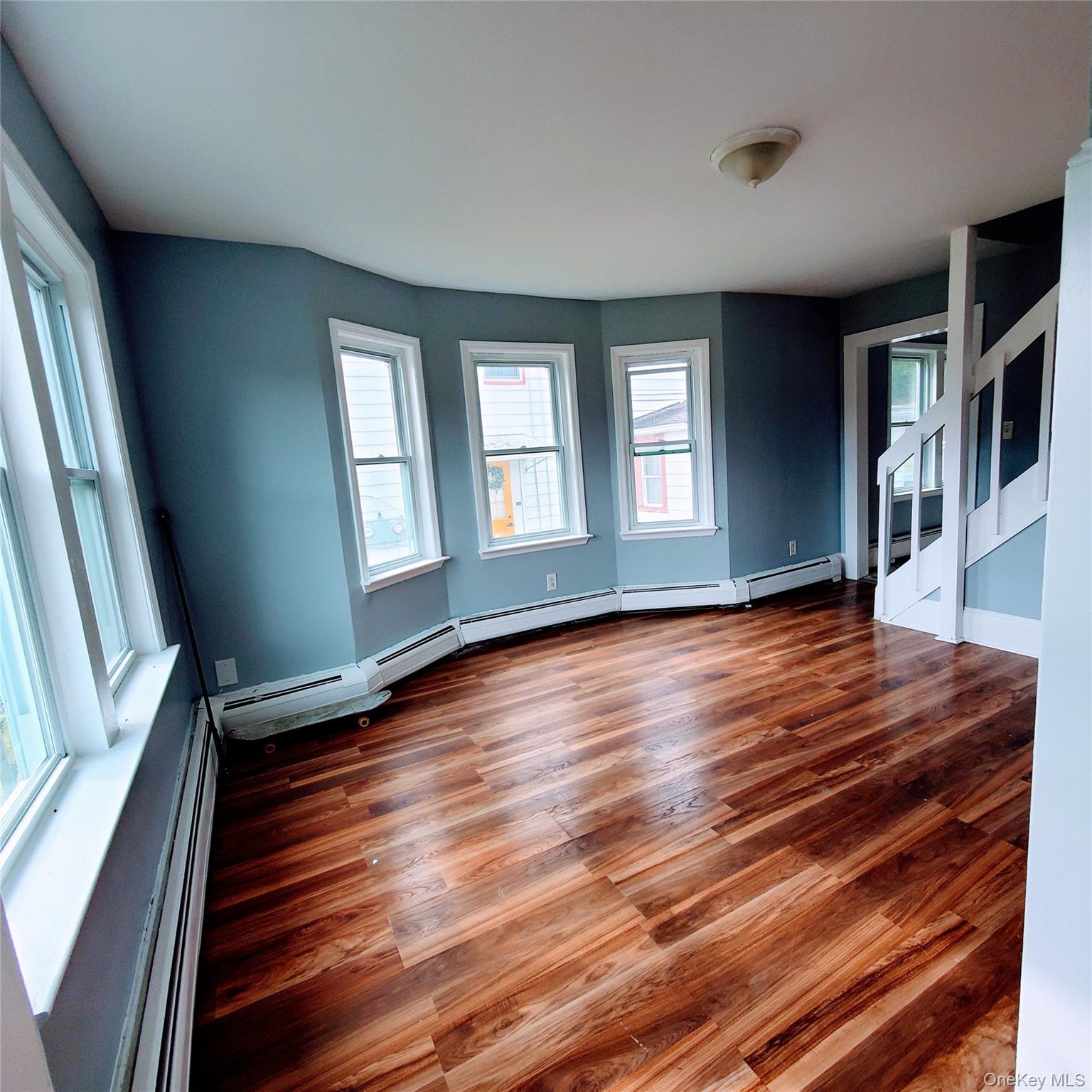 210 Smith Street Poughkeepsie, NY 12601 - Photo 8 of 44 a view of empty room with wooden floor and fan