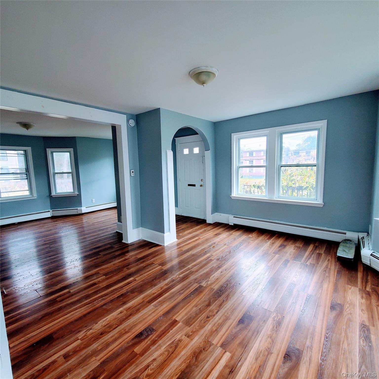 210 Smith Street Poughkeepsie, NY 12601 - Photo 9 of 44 an empty room with wooden floor and windows