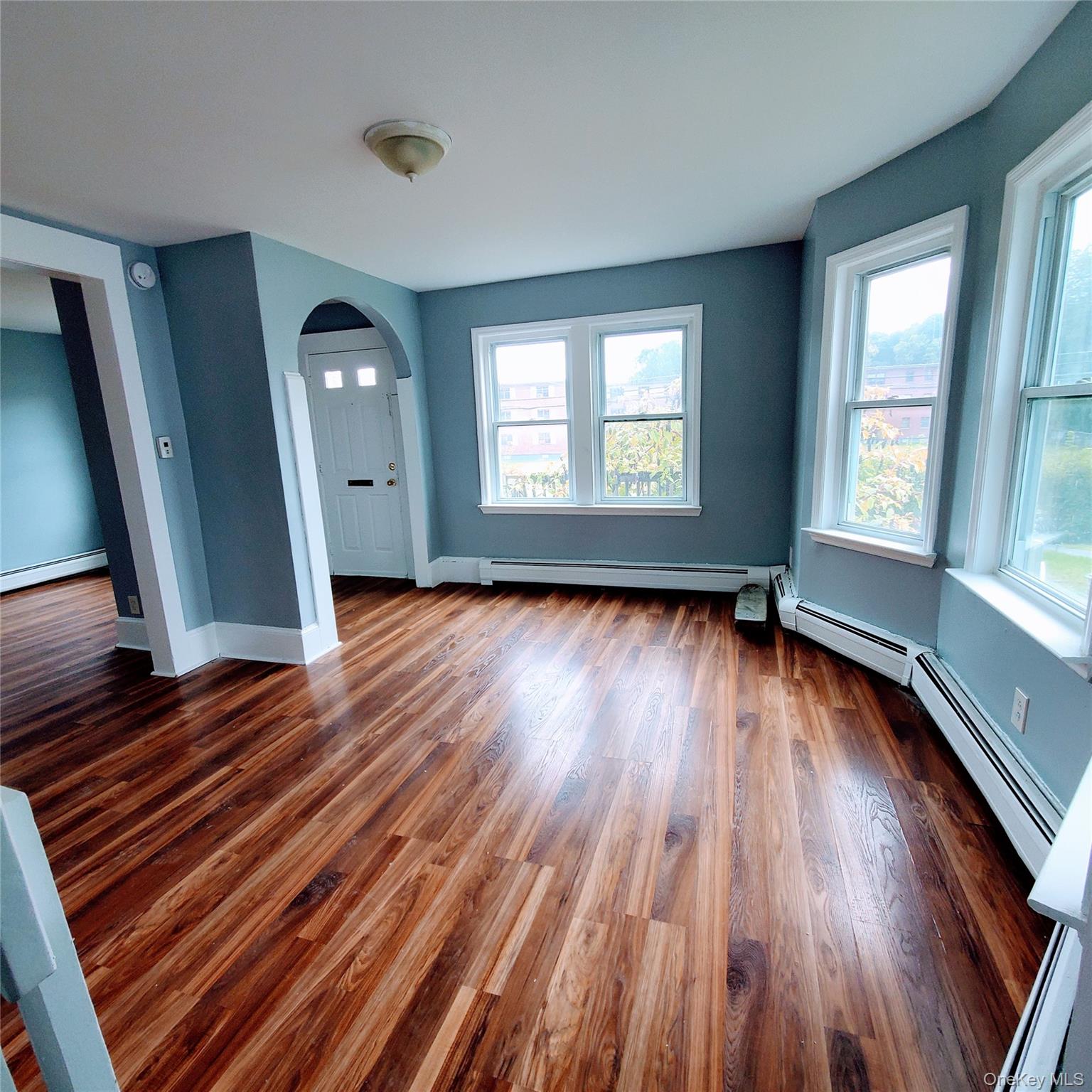 210 Smith Street Poughkeepsie, NY 12601 - Photo 10 of 44 an empty room with wooden floor and windows