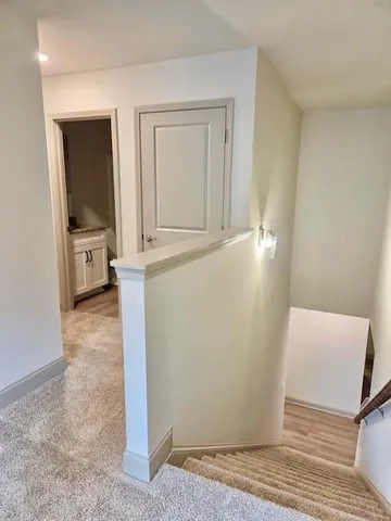 a view of a livingroom with wooden floor and furniture