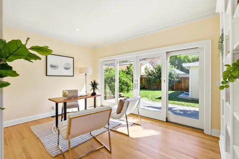 a living room with furniture and a large window with outer view