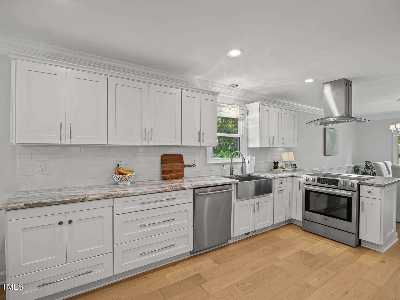 104 Pinecroft Drive Raleigh, NC 27609 - Photo 8 of 33 a kitchen with white cabinets stainless steel appliances and sink