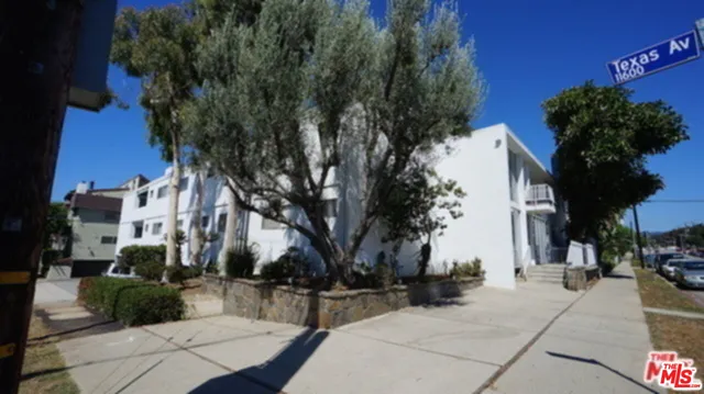 a view of a street with houses on both side
