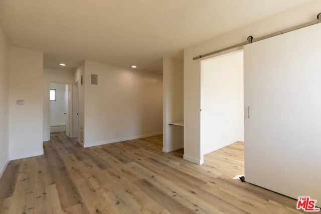 a view of hallway with wooden floor