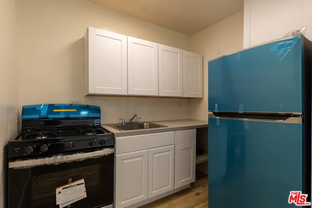a kitchen with a stove and a refrigerator