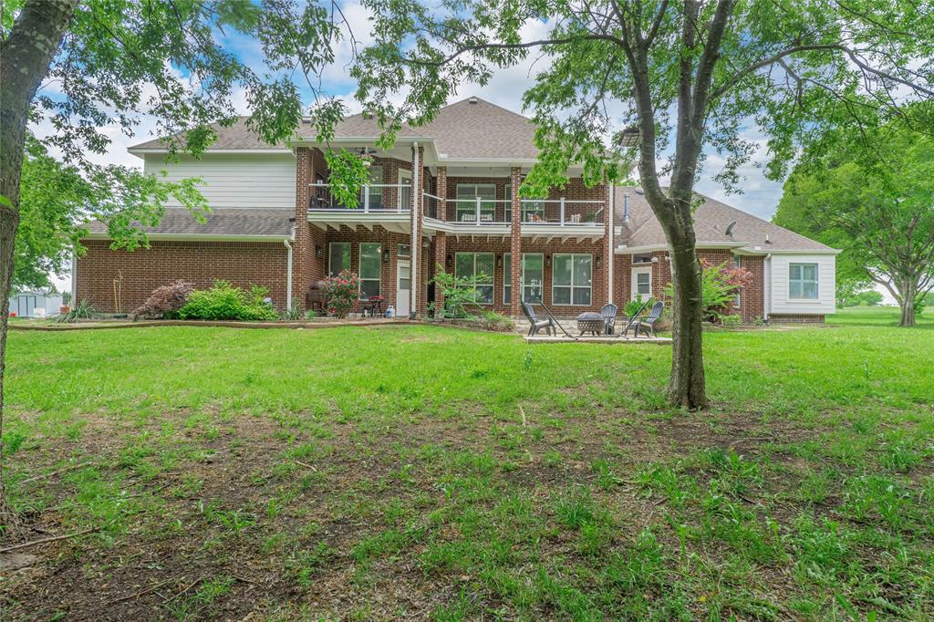 135 Kirkpatrick Road Ennis, TX 75119 - Photo 35 of 40 a front view of a house with a yard and green space