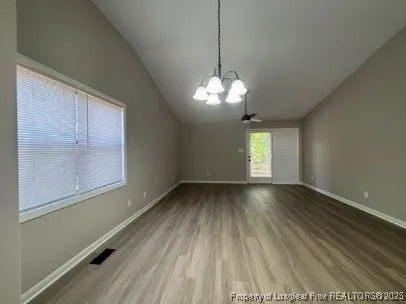 a backyard of a house with barbeque oven table and chairs