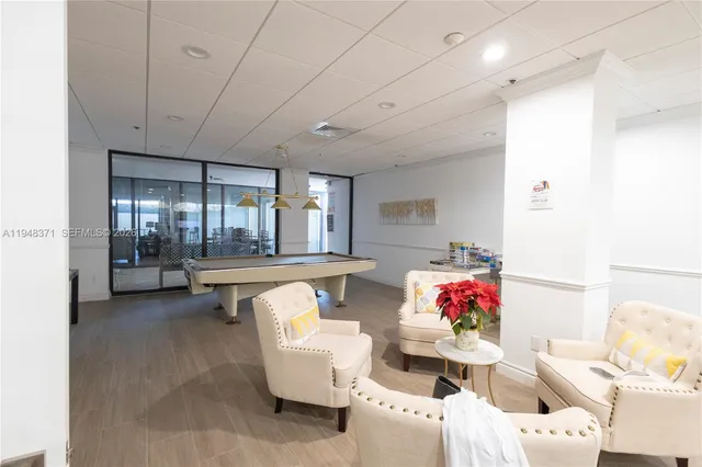 a living room with furniture and a dining table with kitchen view