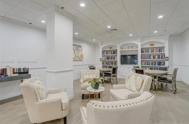 a living room with furniture and a book shelf