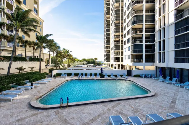 a view of a swimming pool with outdoor seating
