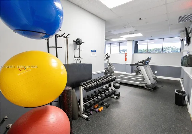 a bedroom with furniture and a large window