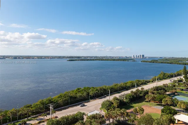 a view of a lake with houses in the back