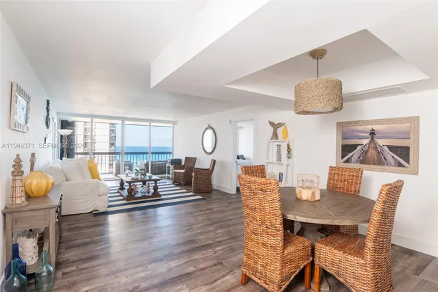a view of a dining room with furniture and wooden floor