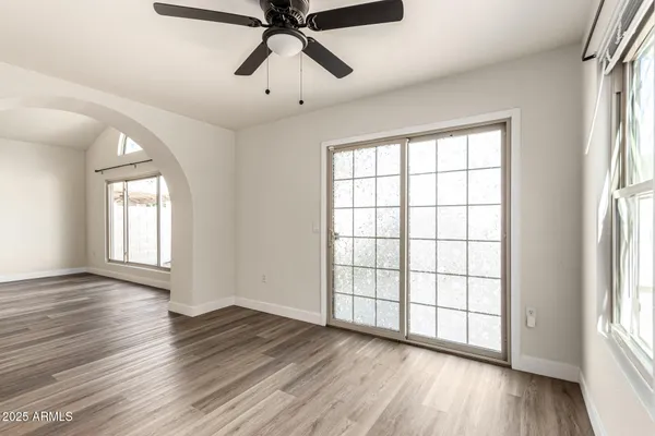 a view of a livingroom with wooden floor and a fireplace